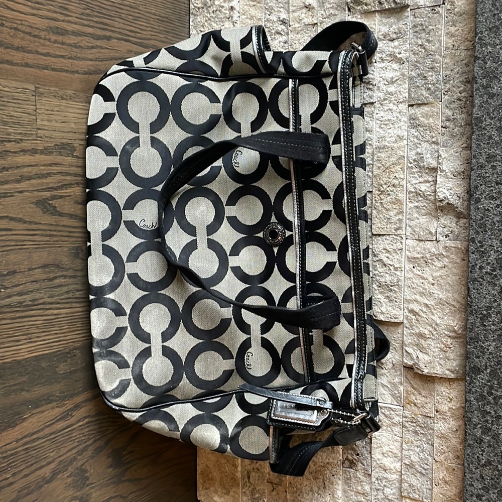 Coach diaper bag. Large with many interior and exterior organizational pockets.